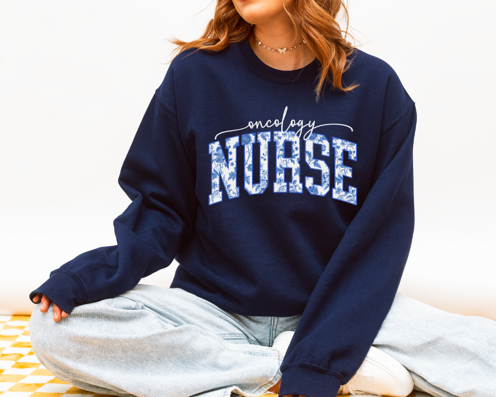 Oncology nurse blue toile sweatshirt in navy styled with jeans