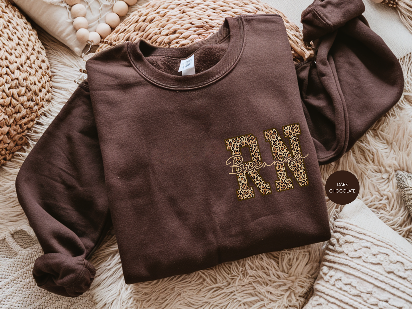 Personalized RN leopard sweatshirt in dark chocolate color, custom nurse gift with leopard print RN design folded flat lay