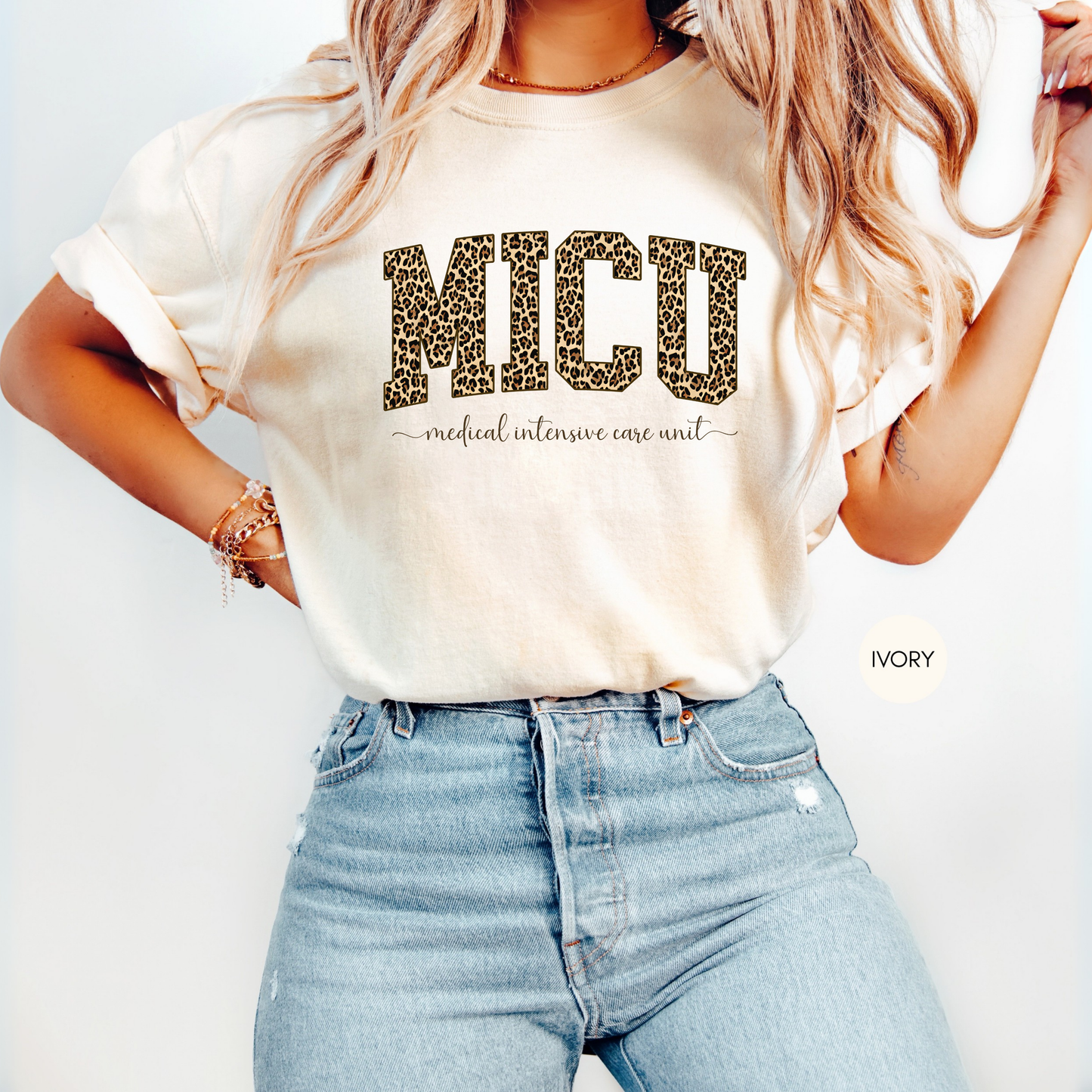 Woman wearing ivory MICU leopard medical intensive care unit nurse shirt