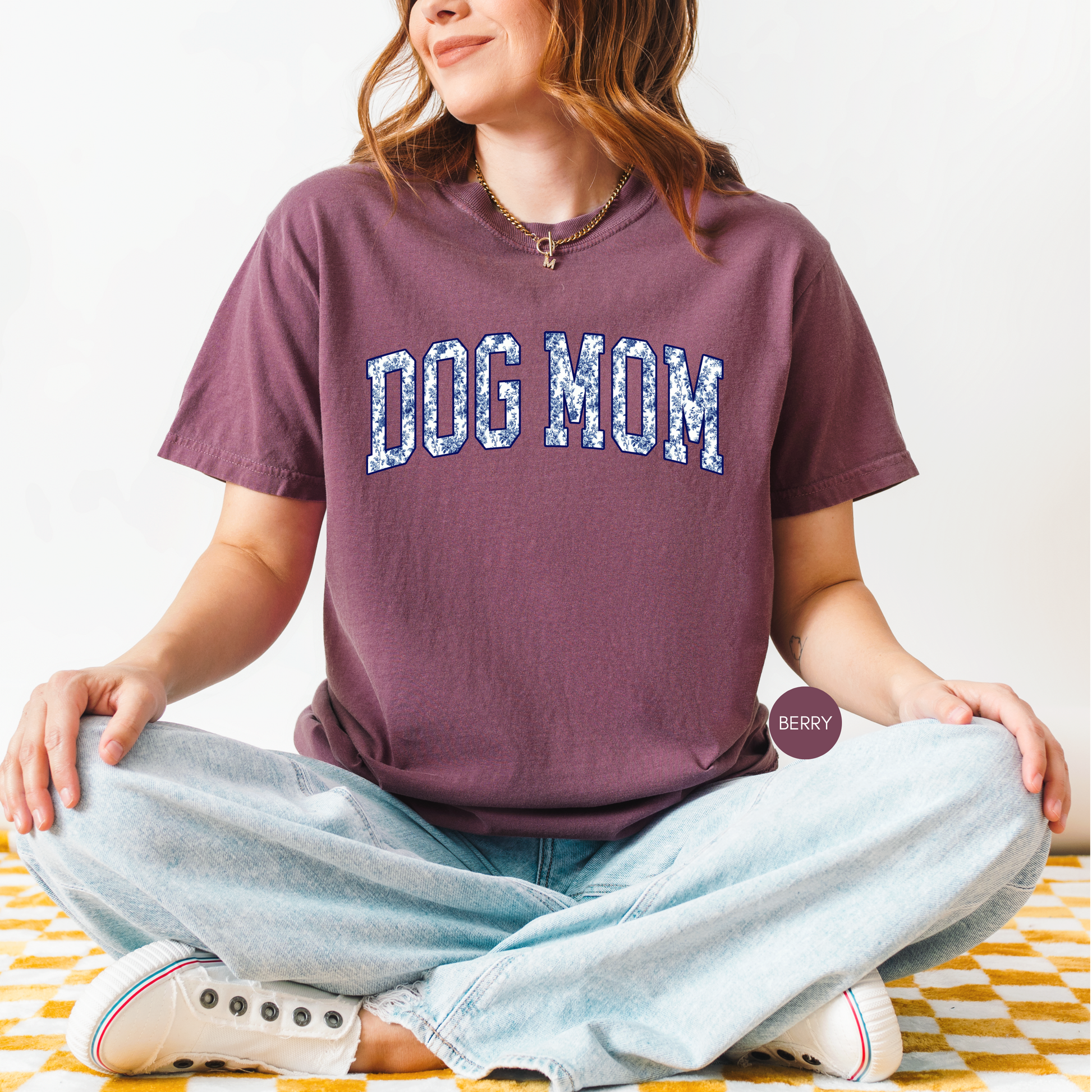 Berry Dog Mom t-shirt with blue floral varsity lettering styled with light wash jeans.