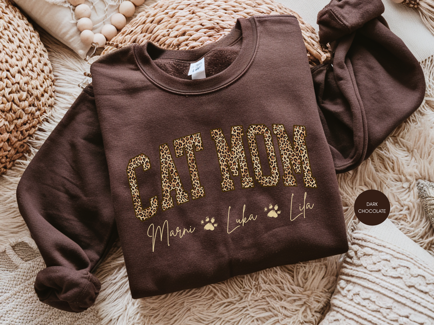 Personalized Cat Mom leopard sweatshirt in dark chocolate color with custom pet names printed underneath.