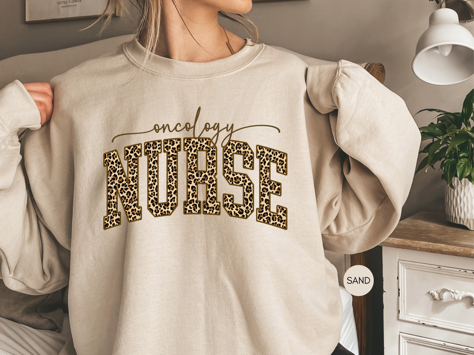 Oncology nurse leopard print sweatshirt in sand color styled with jeans
