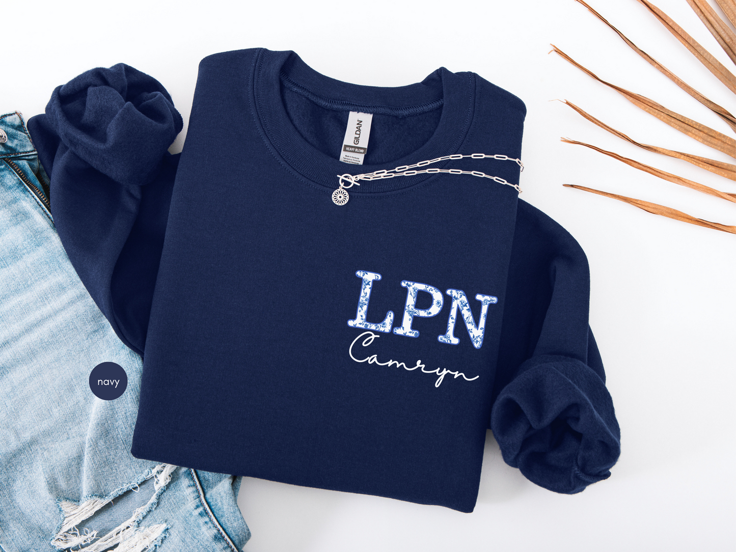 Navy personalized LPN sweatshirt with blue toile lettering and custom name, flat lay nurse crewneck