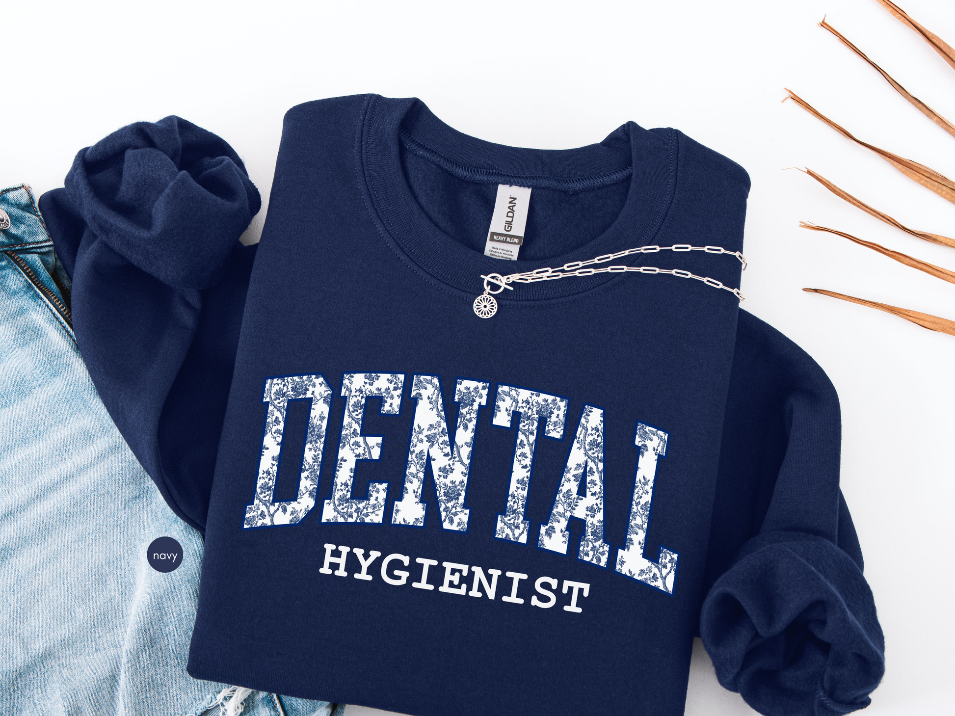 Dental hygienist navy sweatshirt with blue toile typography, flat lay medical apparel gift
